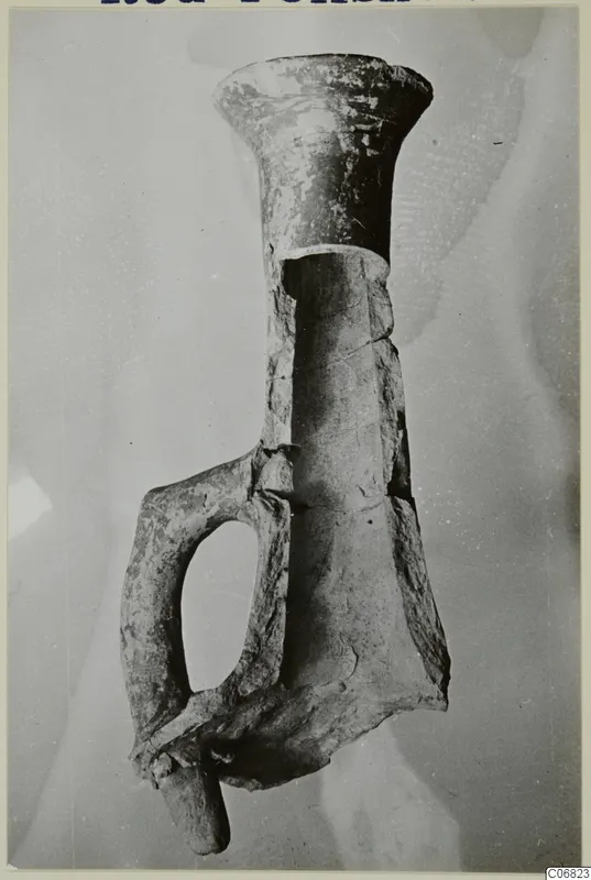Red Polished II jug with a flared neck and a loop handle, photographed against a grey background.
