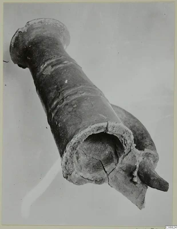 Broken Red Polished II jug from the Vrysi tou Barba tombs at Lapithos, photographed at an angle