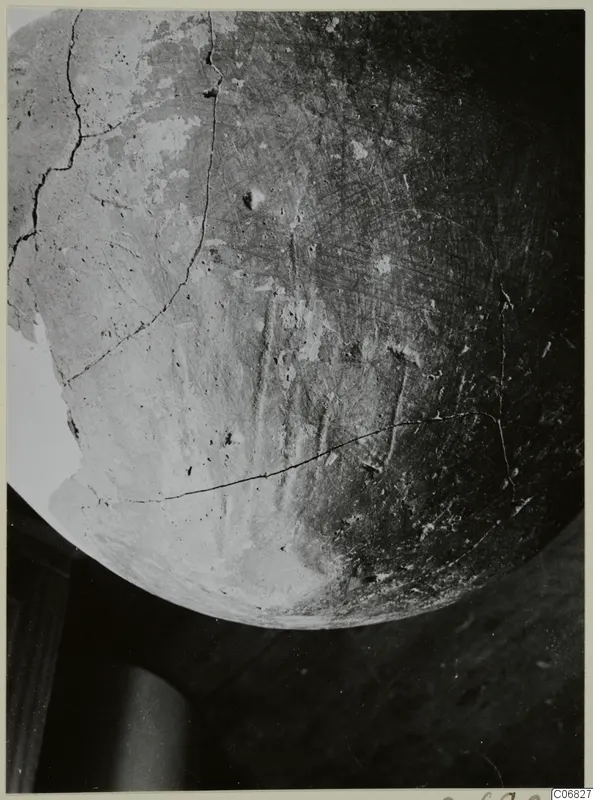 Close view of the rounded body of a Red Polished II jug from Lapithos, its surface cracked and worn.