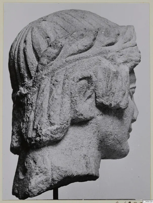 Limestone head in right profile from Mersinaki, with ridged locks of hair and carved bands across the top of the head.