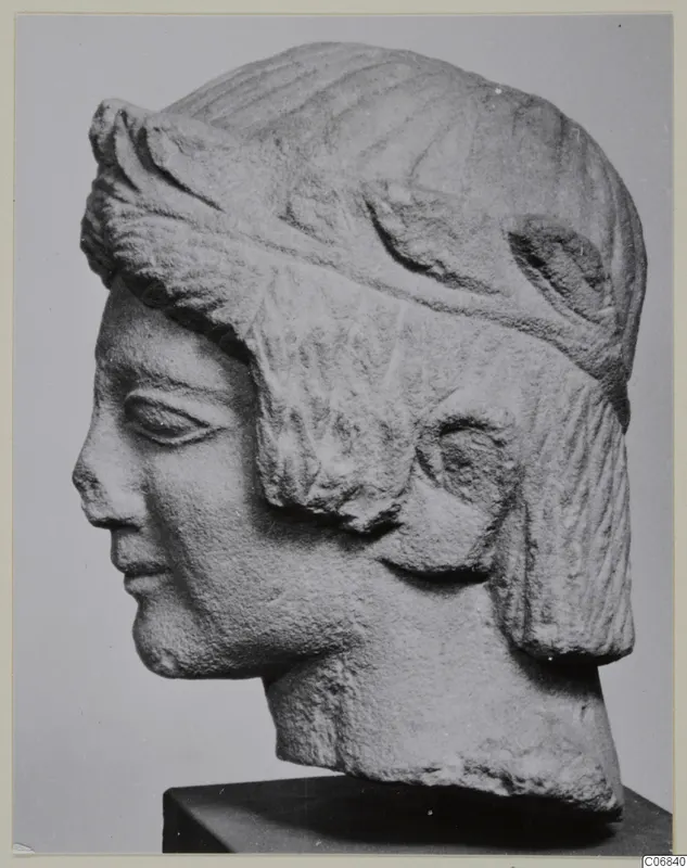 Limestone head from Mersinaki, shown in profile facing left on a dark square base