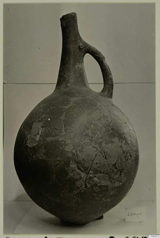 Red Polished I pottery vessel with a single loop handle and tall narrow neck, from the Lapithos tombs
