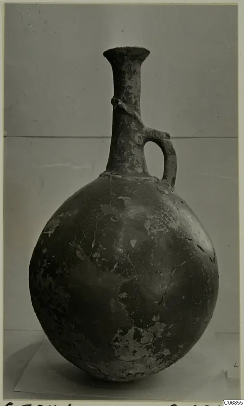 Pottery Red Polished II jug from Lapithos, with a globular body, long neck and loop handle