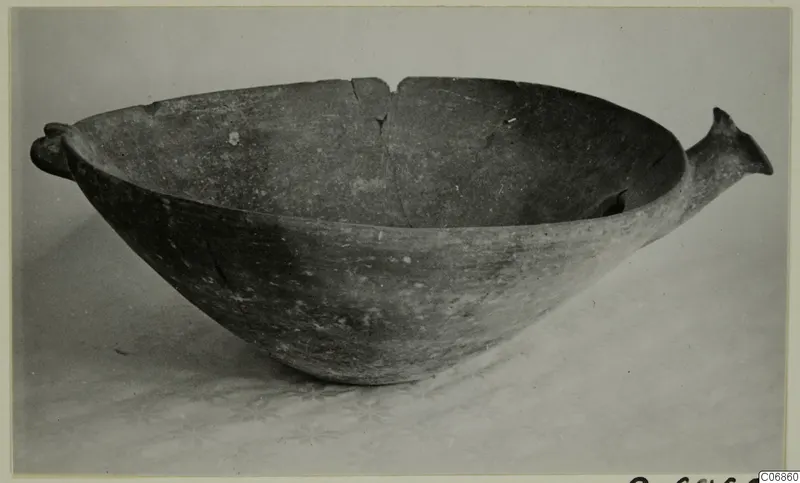 Pottery Red Polished III bowl, deep and rounded, with a knob-like lug on the left rim and a horn-shaped handle on the right.