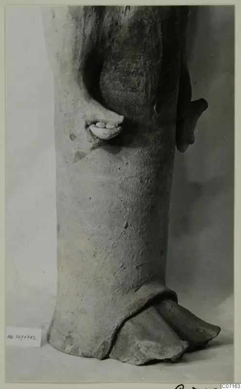 Terracotta statue, lower body with a hand against its side and a broken base, from Mersinaki