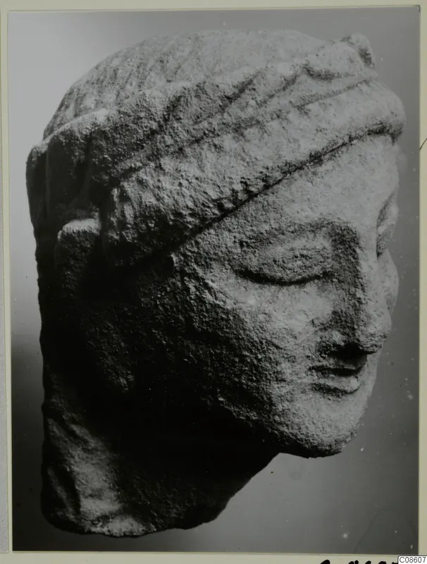 Limestone head from Kition with lowered eyes and a banded headdress