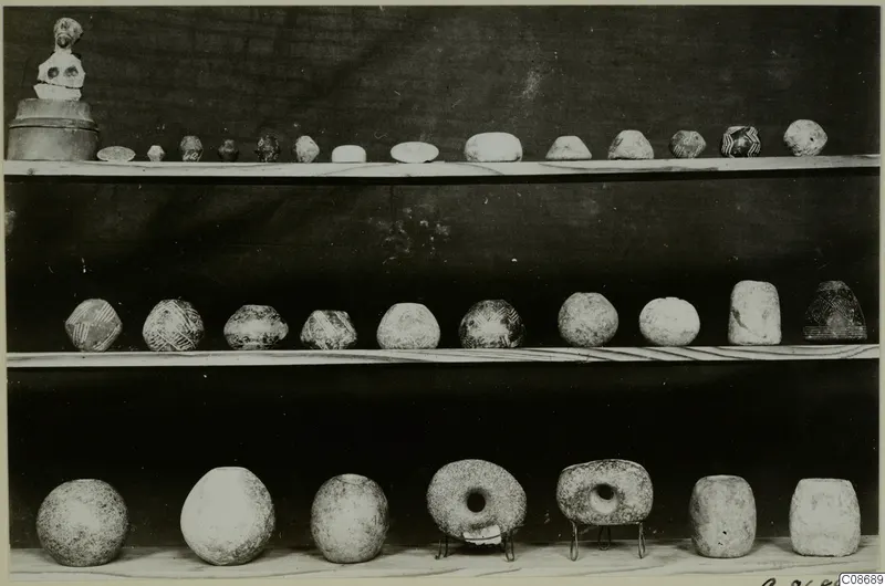 Three shelves of pottery vessels, several with painted patterns, and a small figure, from Cyprus, Cyprus Museum
