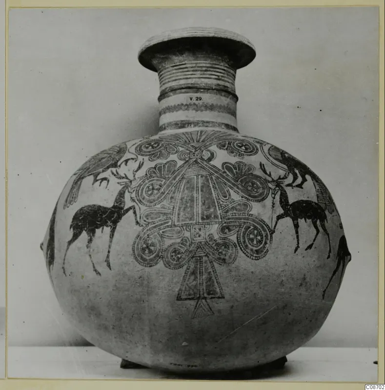 Bichrome IV jug with deer, birds and spiral motifs on a globular body, photographed against a plain background.