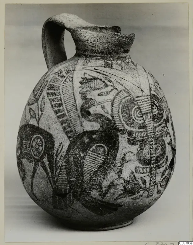 Bichrome IV jug with a single handle, its pale body painted in dark with a large bird-like motif and spirals