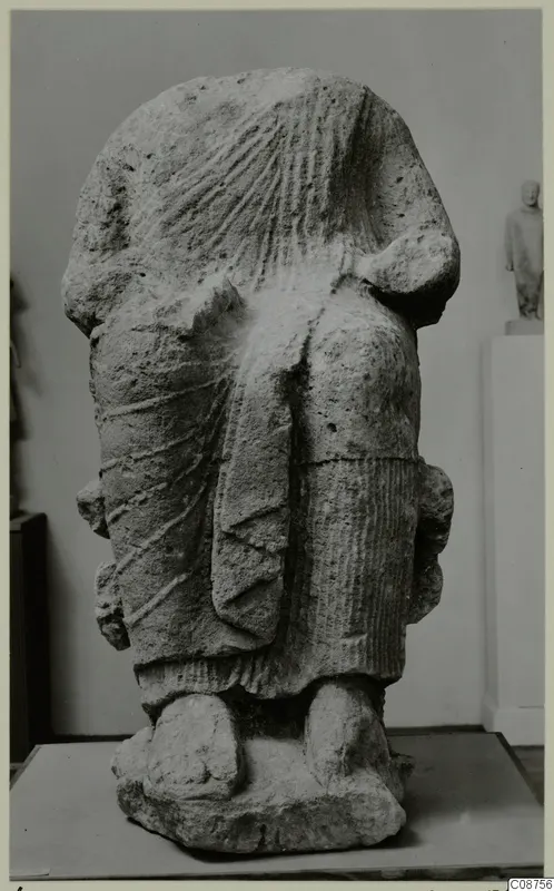 Back view of a Neo-Cypriote limestone statue of a standing figure