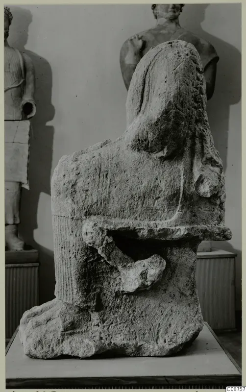 Neo-Cypriote limestone statue fragment with a rounded head, broken arm and rough, weathered surface