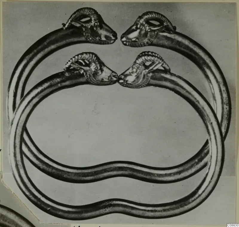 Two gold bracelets from Vouni with ram-head terminals, overlapping and facing each other in pairs