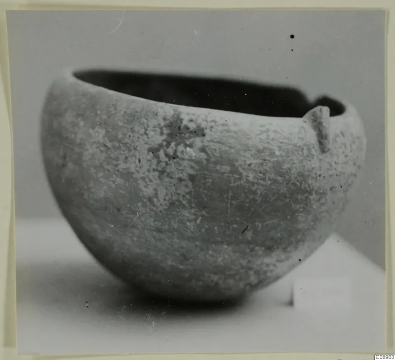 Red Polished I bowl with a small lug on the rim, photographed against a plain grey backdrop