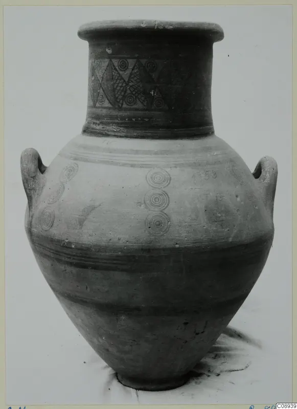 Two-handled painted jar with lozenges and concentric circles on the neck and concentric circles on the body.