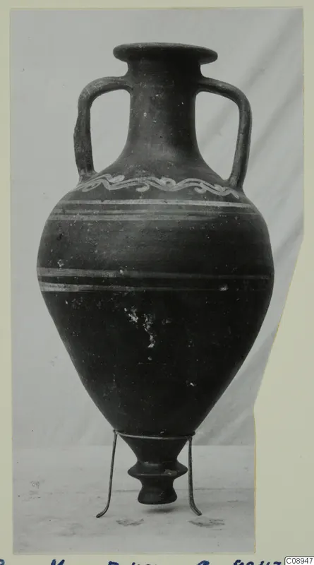 Two-handled jar with a wavy painted band on the shoulder and pale horizontal stripes around the body