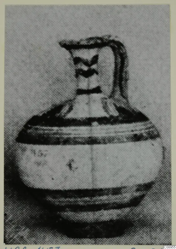 White Painted I jug with a single strap handle and dark painted bands on the body