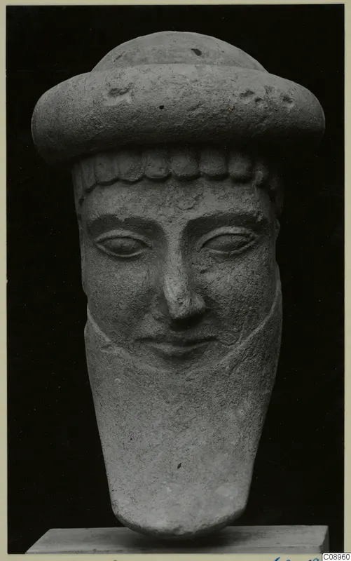 Limestone head of a figure wearing a wide cap, from Idalion