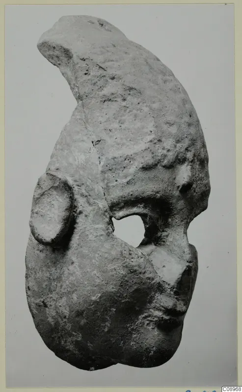 Terracotta fragment from Vasilika with a curved upper part, a rounded opening and a raised knob on one side