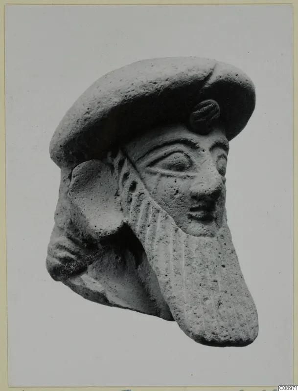 Terracotta head of a bearded figure from Vasilika, wearing a flat cap, shown in three-quarter view