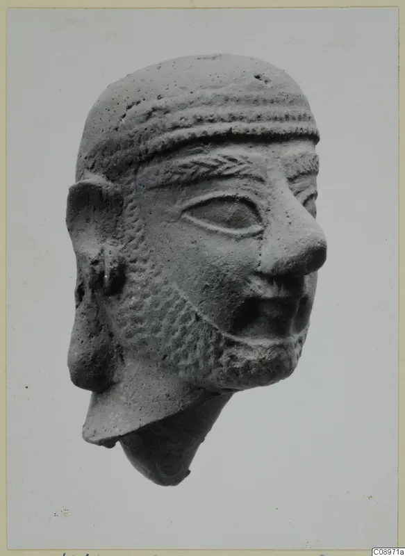 Terracotta head of a bearded man from Vasilika, with a banded headband and incised beard, neck broken off