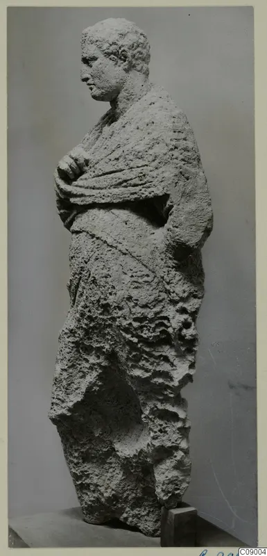 Limestone statue of a standing male figure in a draped cloak, from Mersinaki