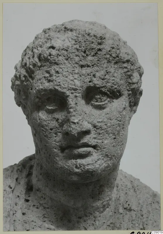 Limestone head of a male figure from Mersinaki, seen from the front with short curly hair