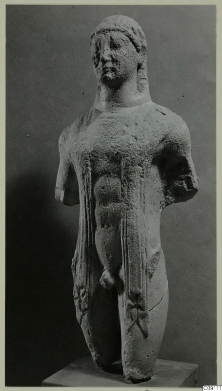 Limestone statue of a standing male figure with both arms broken off, set on a plain stone base
