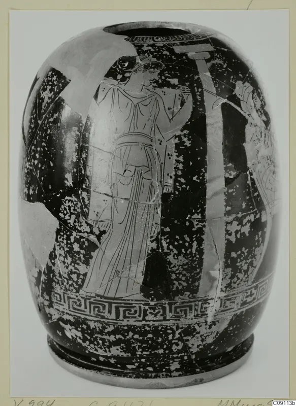 Red figured ware vessel with a standing figure in a long robe, a band of interlocking spirals below, on a card mount