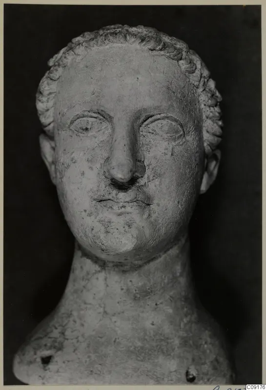 Stone head and upper bust of Domitianus, facing forward against a dark background