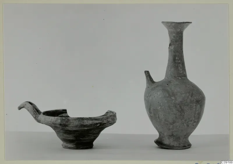 Pottery Base-Ring Ware: a shallow bowl with a curved spout-handle and a juglet with a tall flaring neck