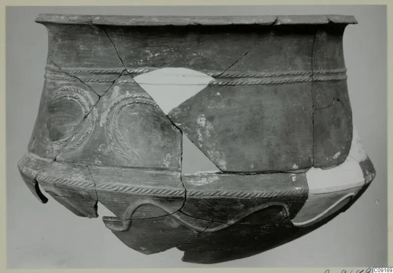 Pottery Base-Ring Ware vessel, reconstructed from fragments, with rope-moulded bands and looped decoration on the body