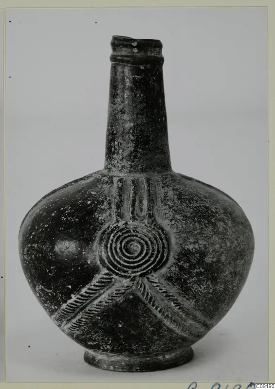 Base-Ring Ware bottle-shaped vessel with a long neck, concentric-circle relief and rope-moulded bands on the body