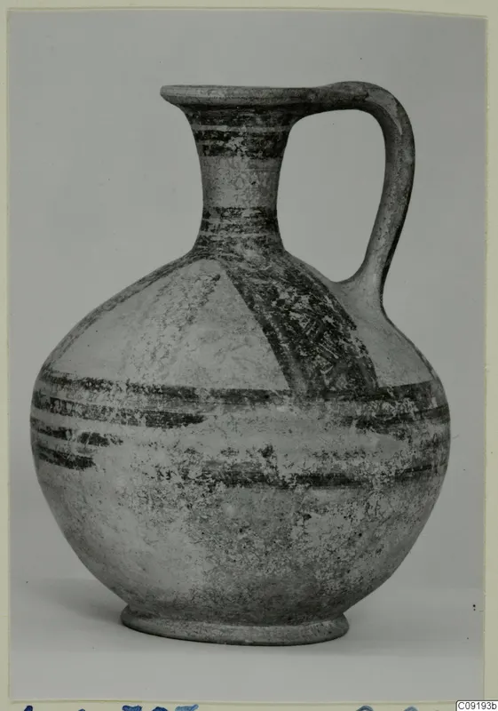 Pottery Bichrome Wheel-made jug with a strap handle and dark painted bands