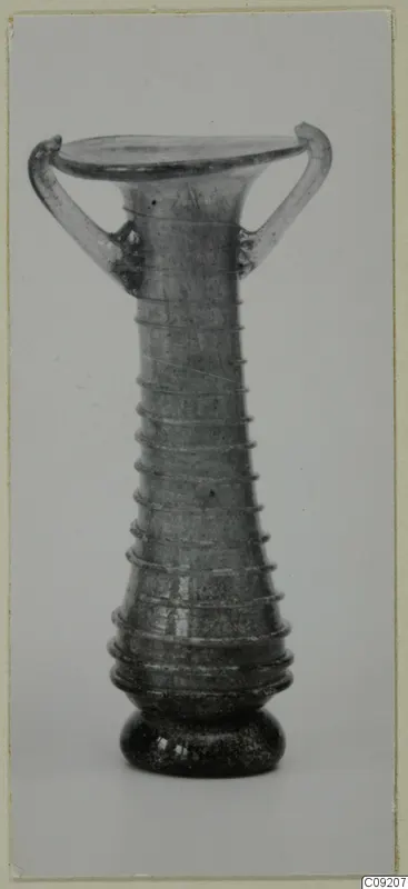 Blown glass unguentarium with two handles, a flared mouth and trailed threads around the body