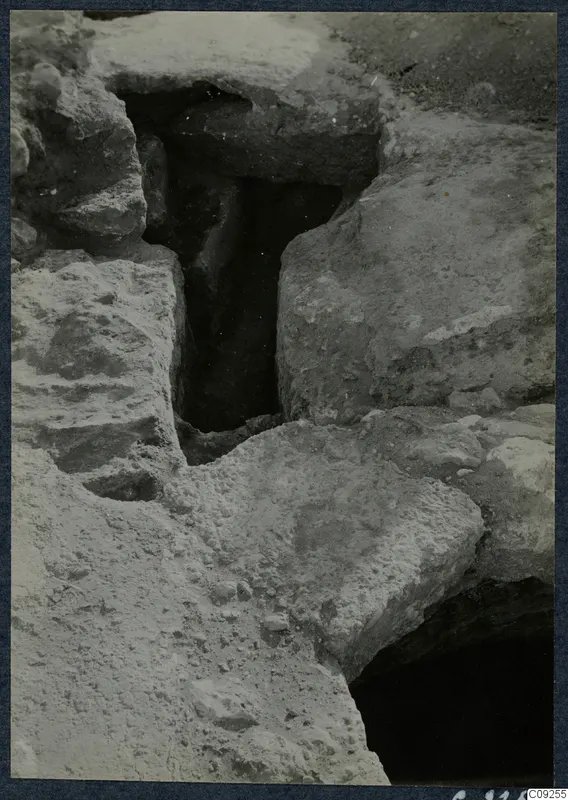 Excavated stone-lined opening with dark cavity at the palace at Vouni