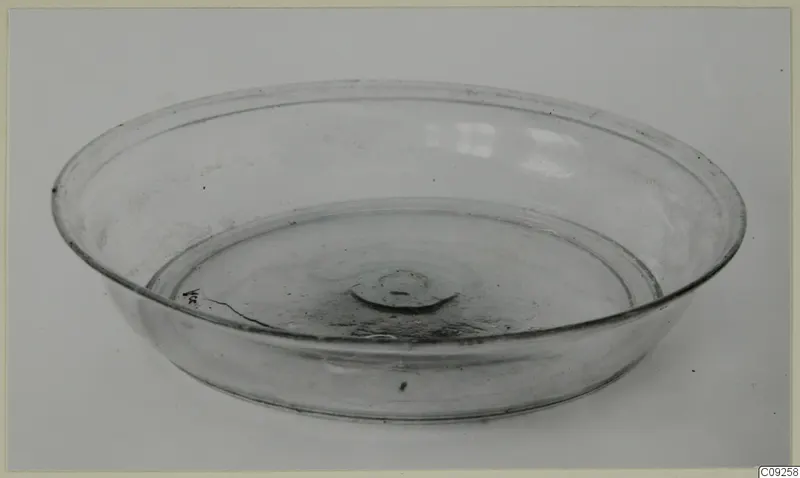 Shallow blown glass bowl with a central pontil mark, shown on a pale background.