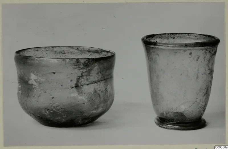 Two blown glass beakers photographed side by side on a plain background