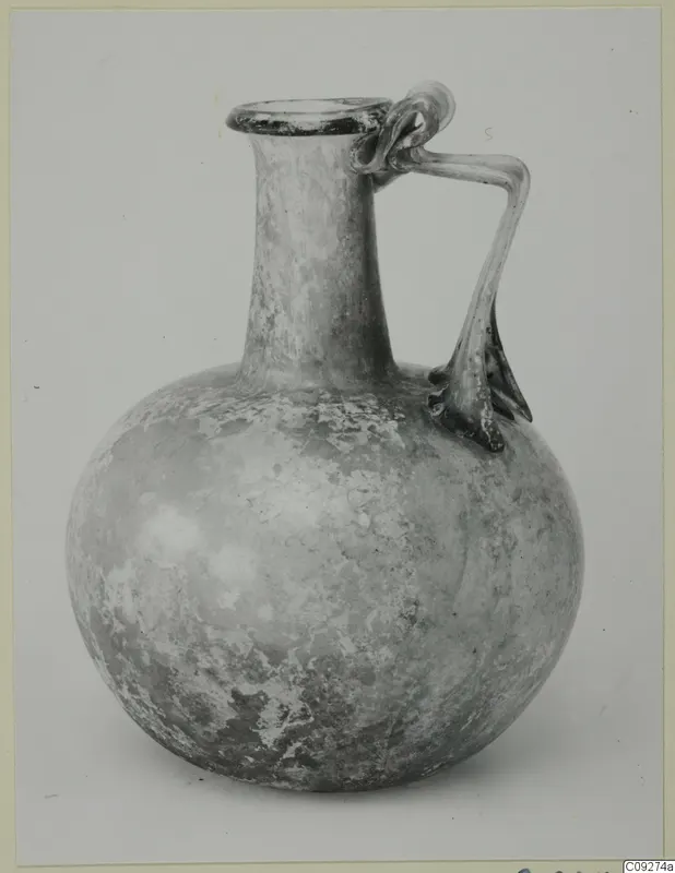 Blown glass jug with a round body, long neck and handles