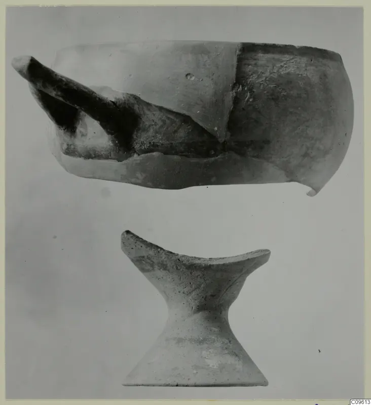 Two pottery objects: a broken vessel with a spout-like projection above, and a pedestal-shaped piece below.