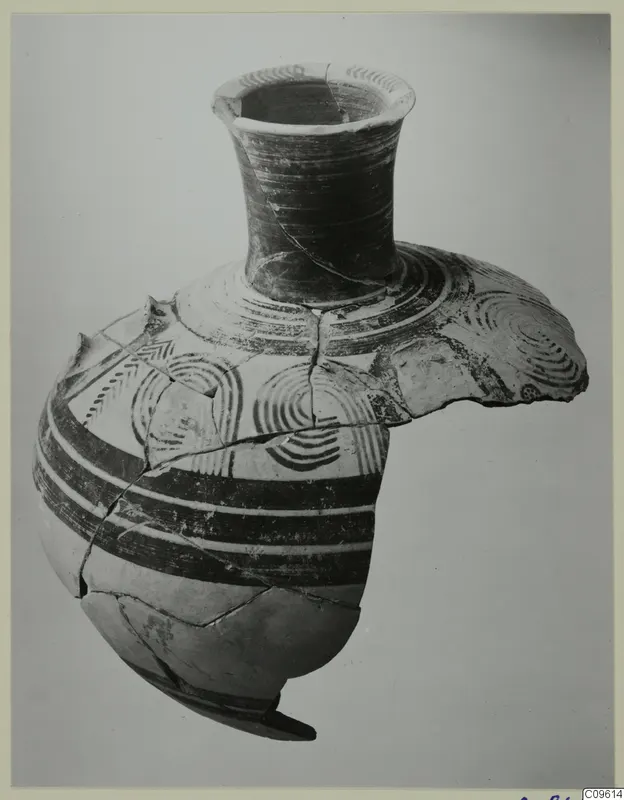 Reassembled painted pottery vessel with a flaring neck, dark bands and concentric circle designs