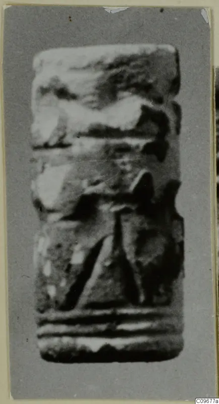 Cylinder seal from Ayios Iakovos, photographed upright, with carved bands and a central motif.