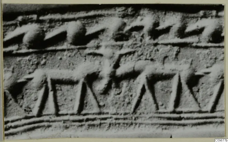 Close-up of an engraved surface showing a row of four-legged animal figures in a band