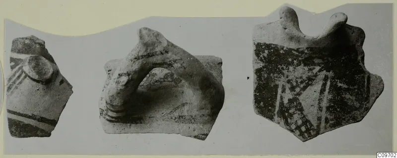 Three Levanto-Helladic pottery sherds with painted bands and projections, shown side by side on a card mount