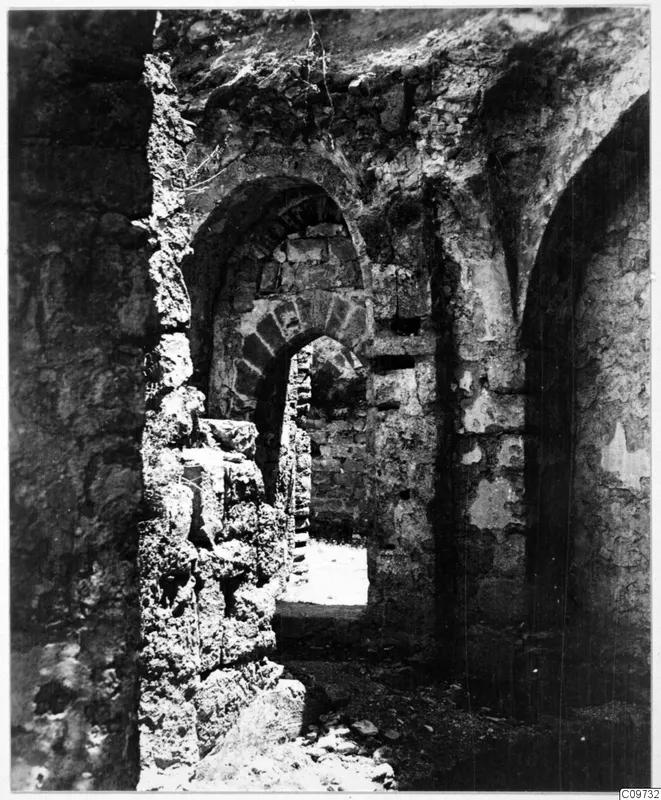 Ruined stone walls and arched openings with loose stones on the ground, Kyrenia Mountains