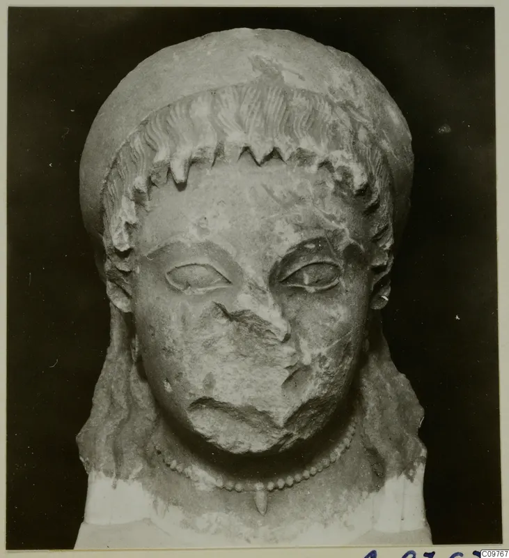 Limestone head from Arsos, frontal view, with the nose and mouth broken