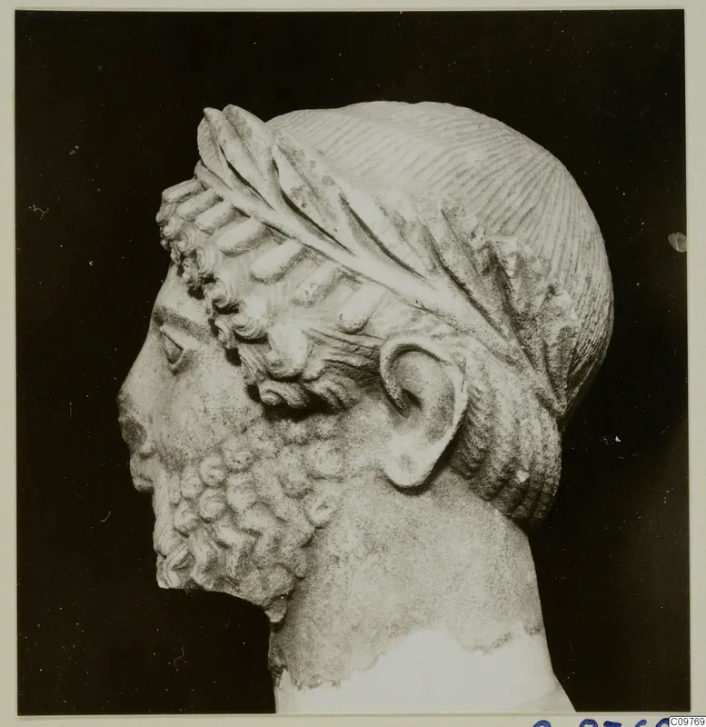 Sculpted stone head of a bearded man in left profile, from Arsos, with a leaf band in the hair.