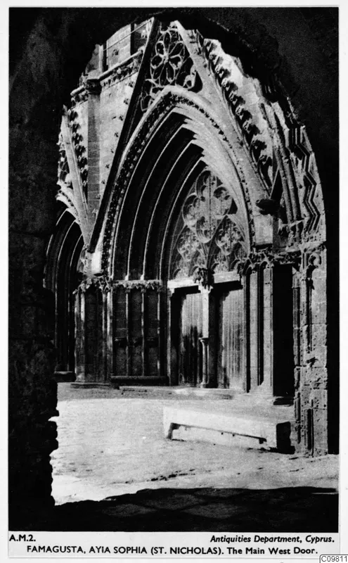 Central west doorway of St Nicholas cathedral, Famagusta, with a pointed arch, carved mouldings and tall wooden doors