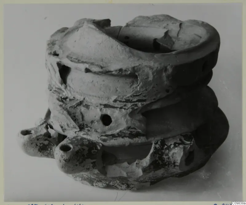 Terracotta lamp from Mersinaki, several rounded lamp bodies stacked together with a broken rim