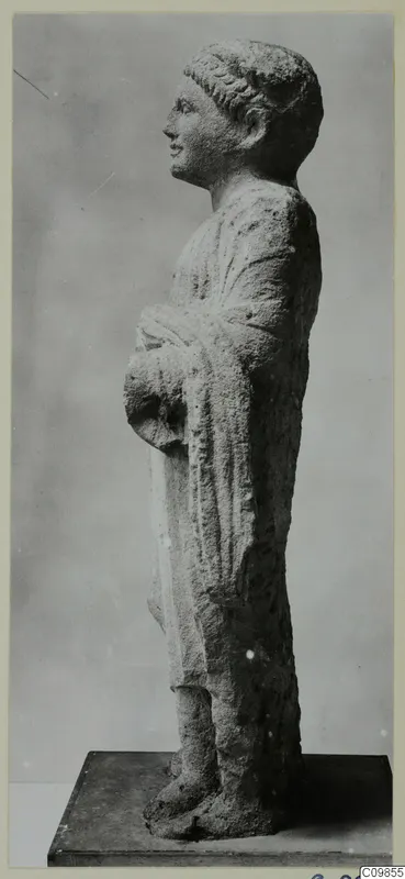 Limestone statue of a standing figure in profile, with a draped cloak, from Mersinaki
