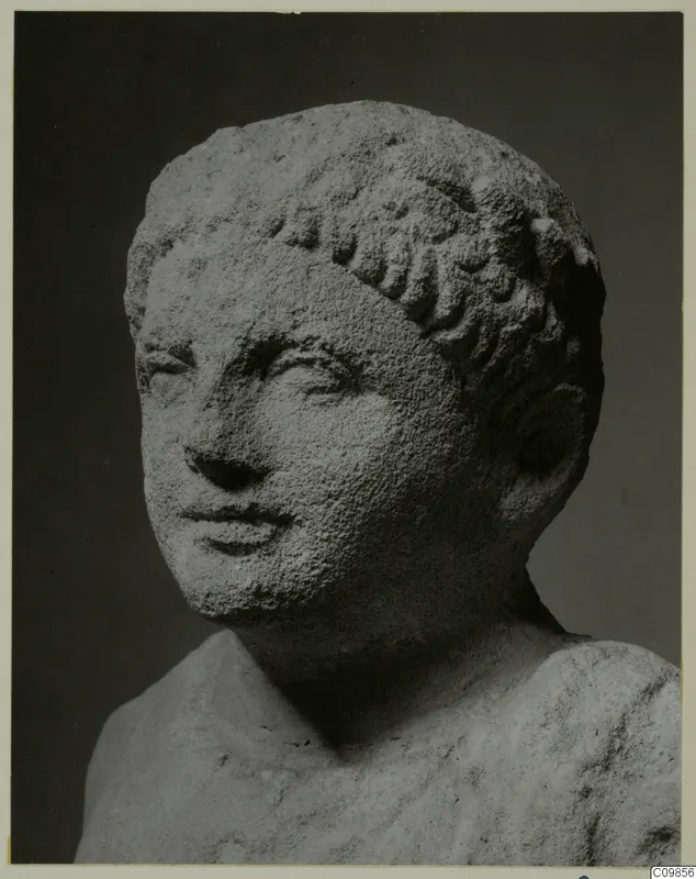 Limestone head and upper body of a young figure with short curled hair, from Mersinaki